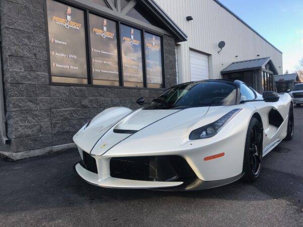 Hydrophobic ceramic coating repelling water on car hood
